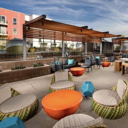 CALLING IN those who love a vibrant, modern lifestyle. outside lounge area with colorful seating